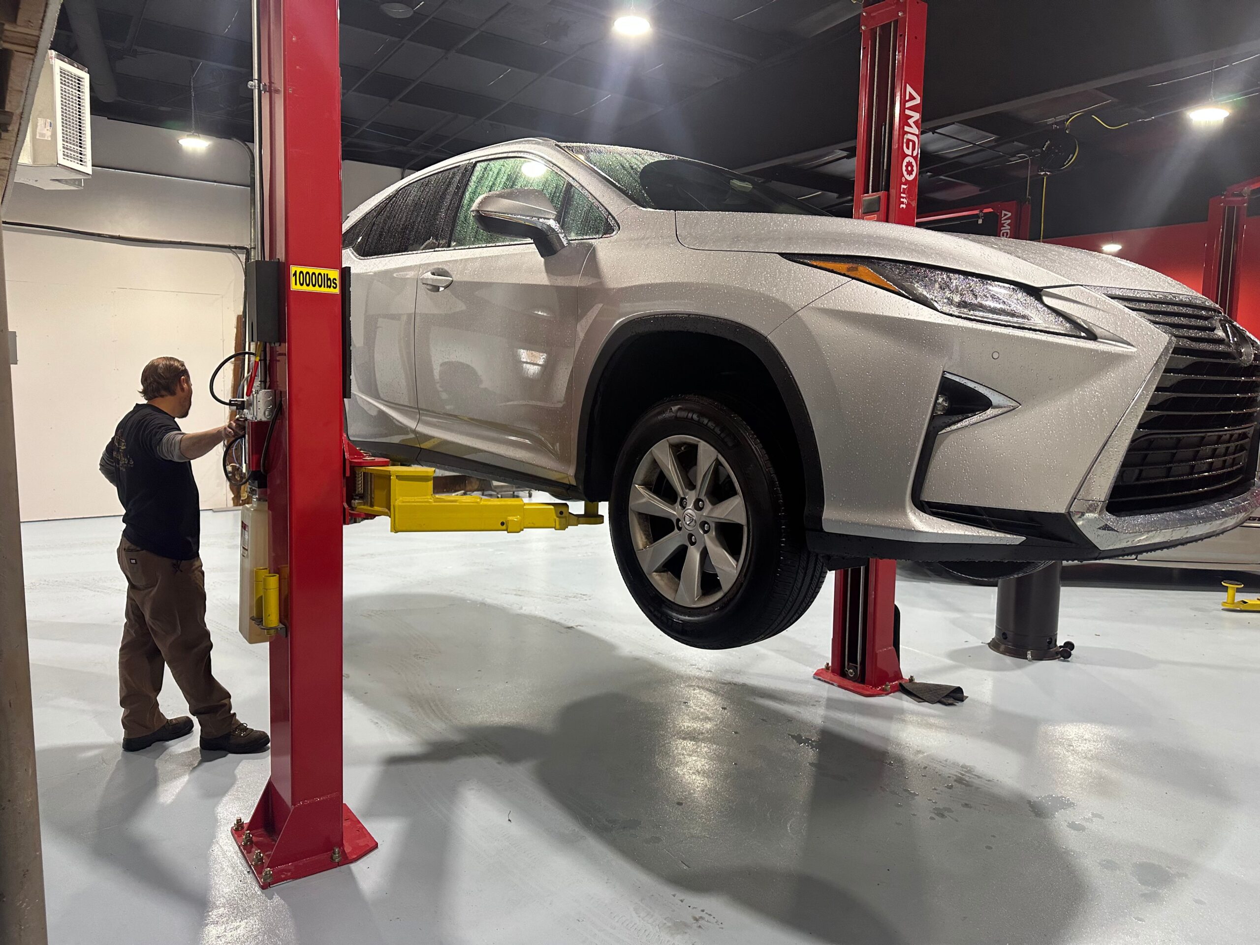 mechanic Jason Glemser putting car up in lift