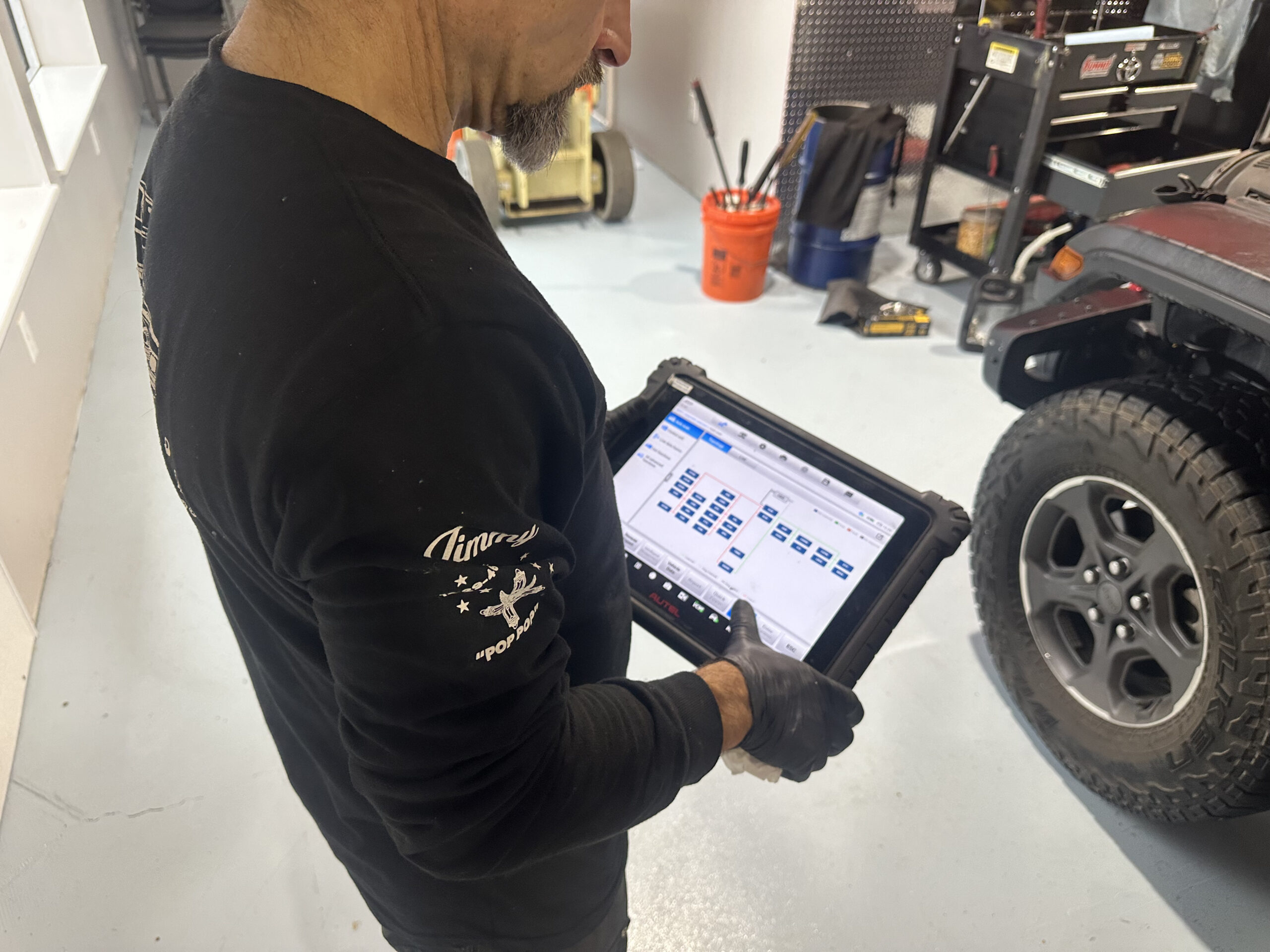 mechanic evaluating tablet with diagnostics information