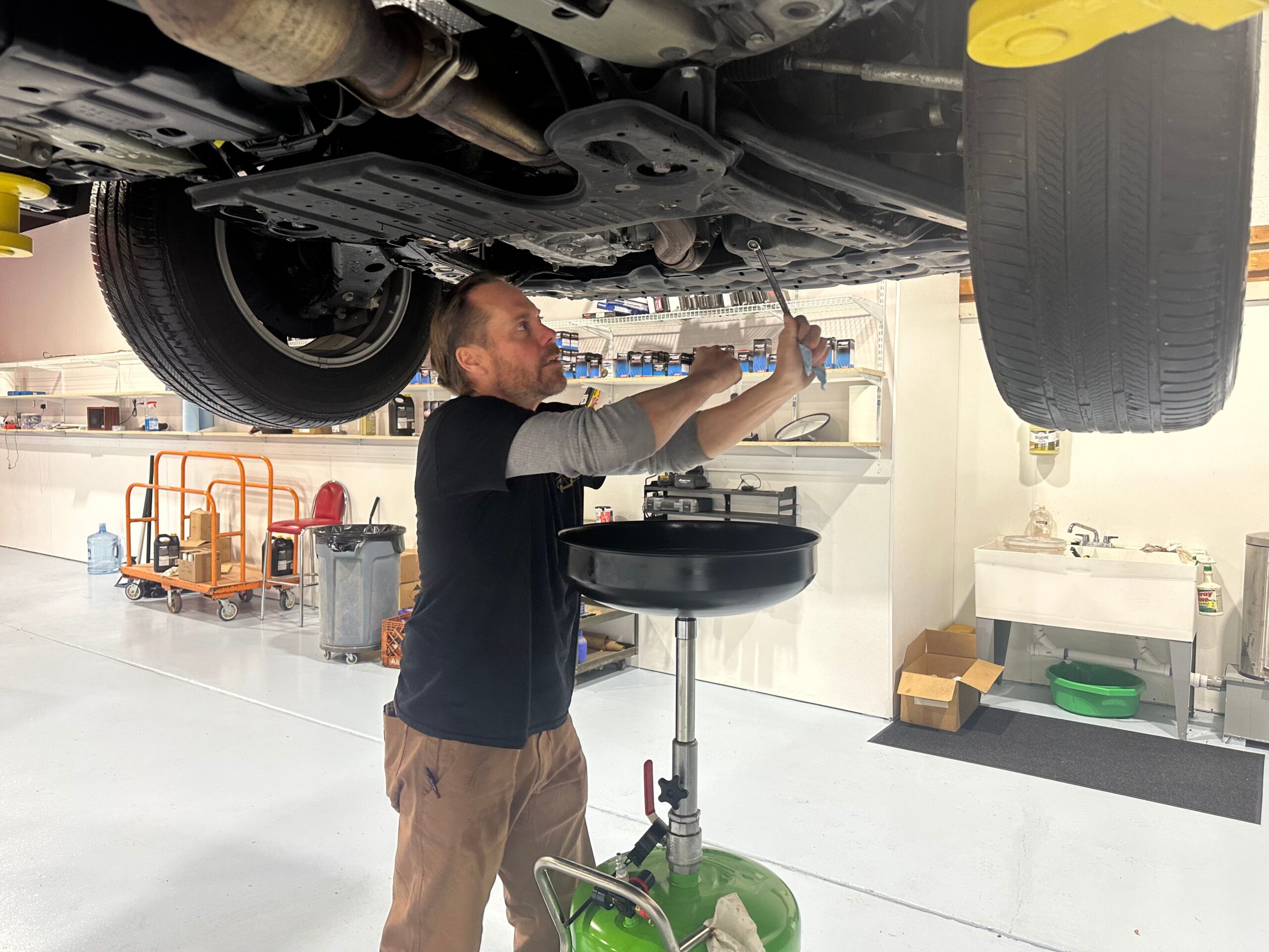 mechanic jason glemser conducting oil change