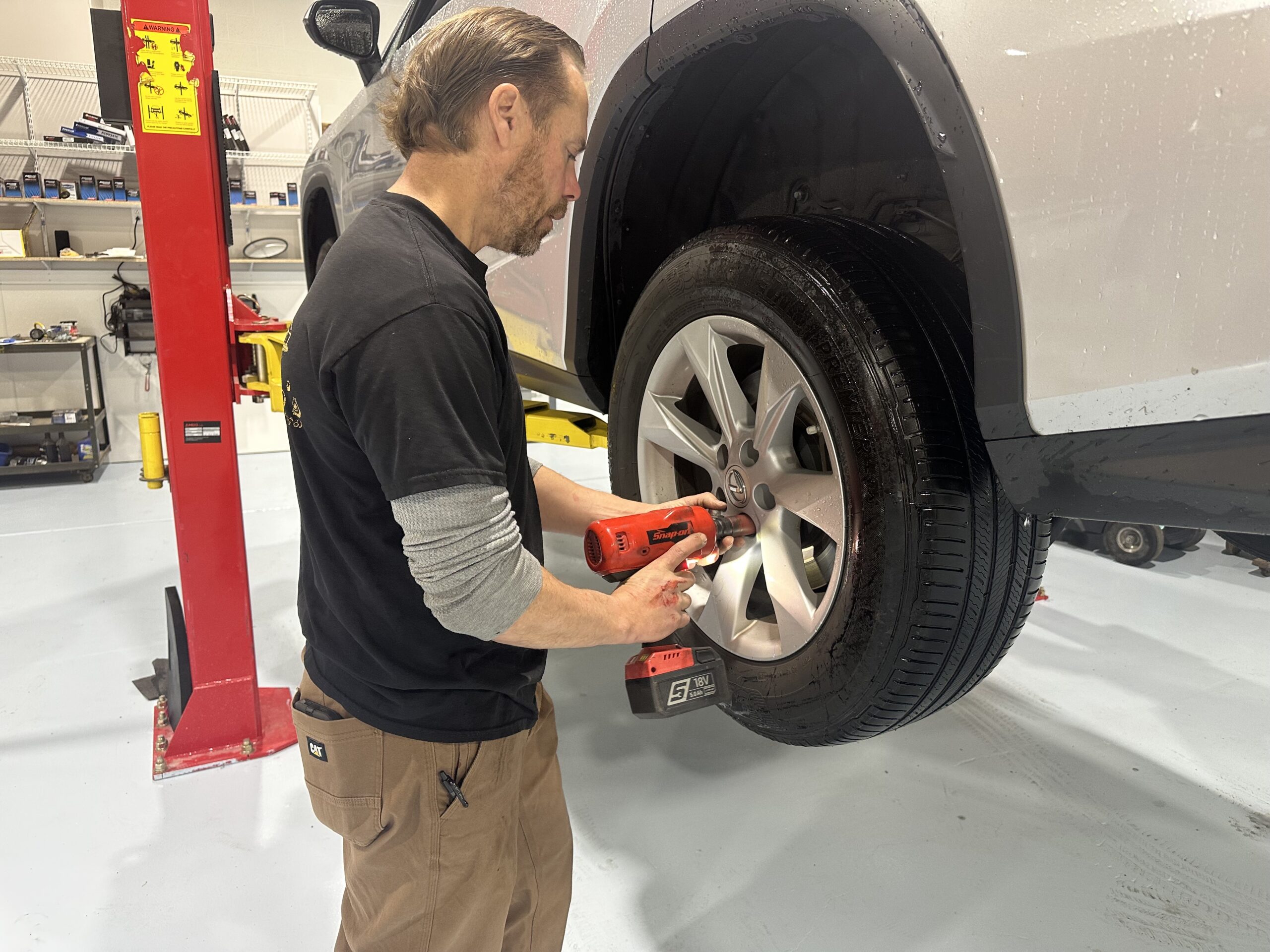mechanic Jason Glemser removes tire on lift